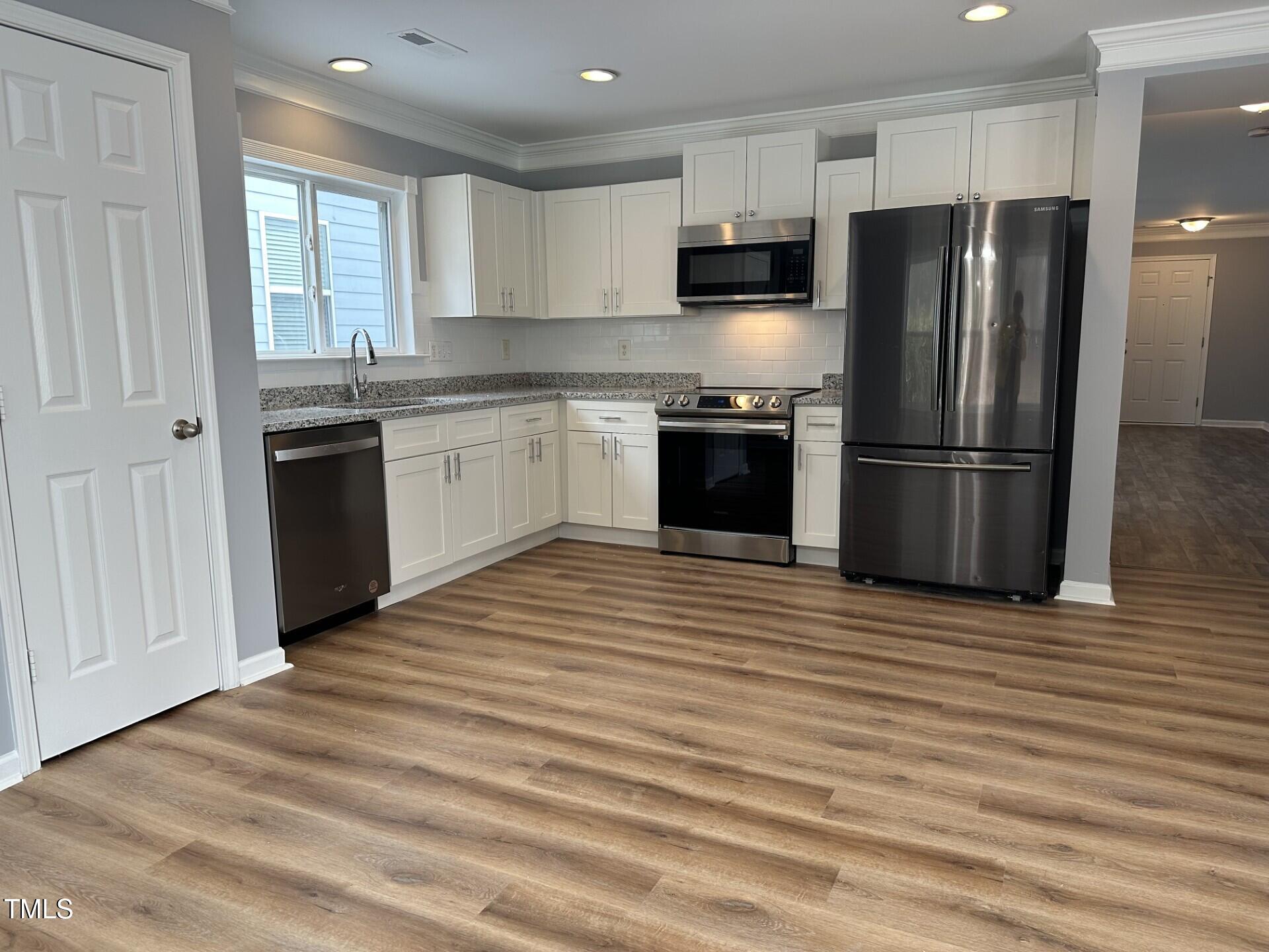 336 New Milford Road Cary, NC 27519 - Photo 15 of 53 a kitchen with a refrigerator stove top oven and sink