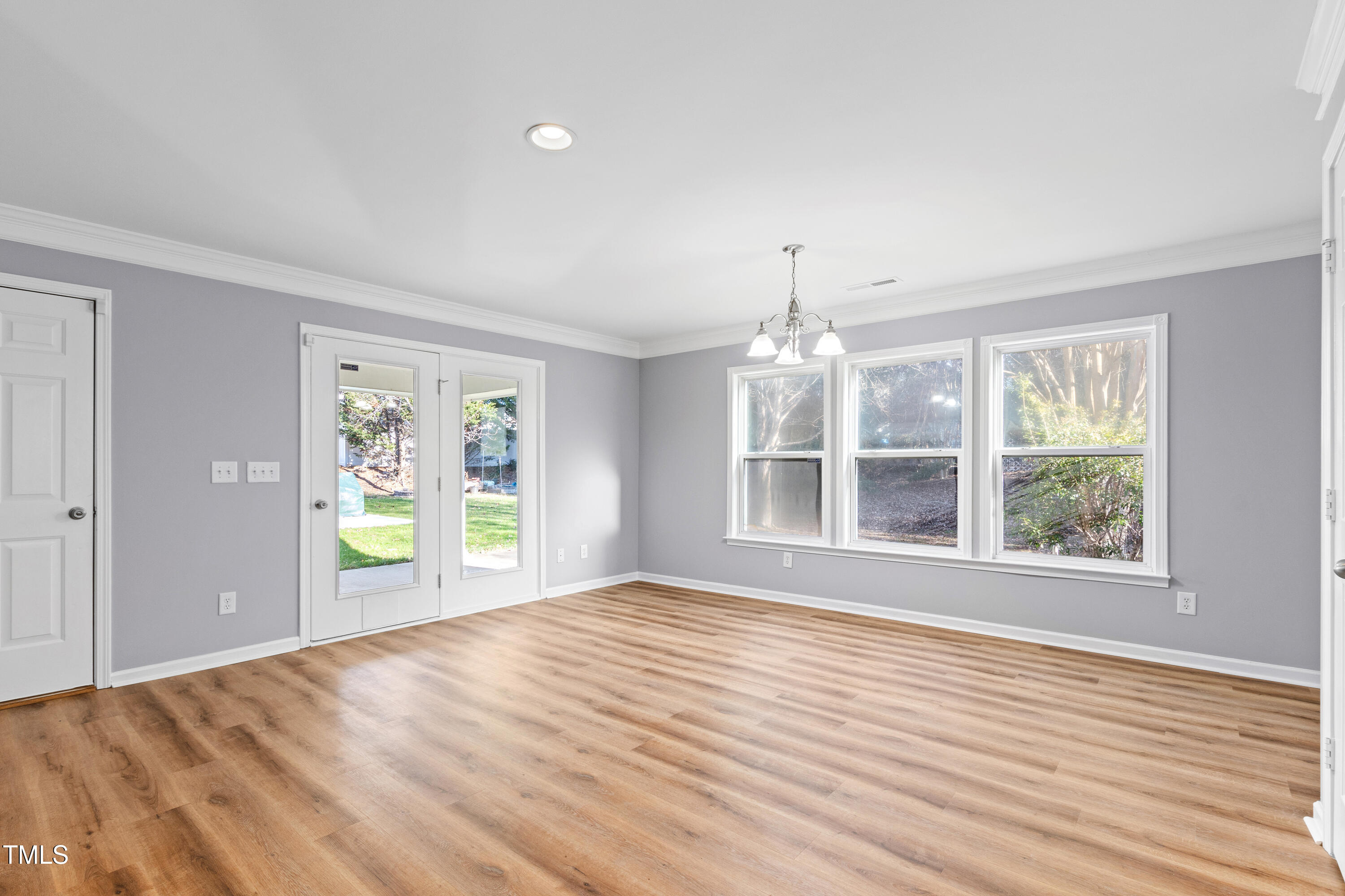 336 New Milford Road Cary, NC 27519 - Photo 17 of 53 a view of an empty room with a window and wooden floor