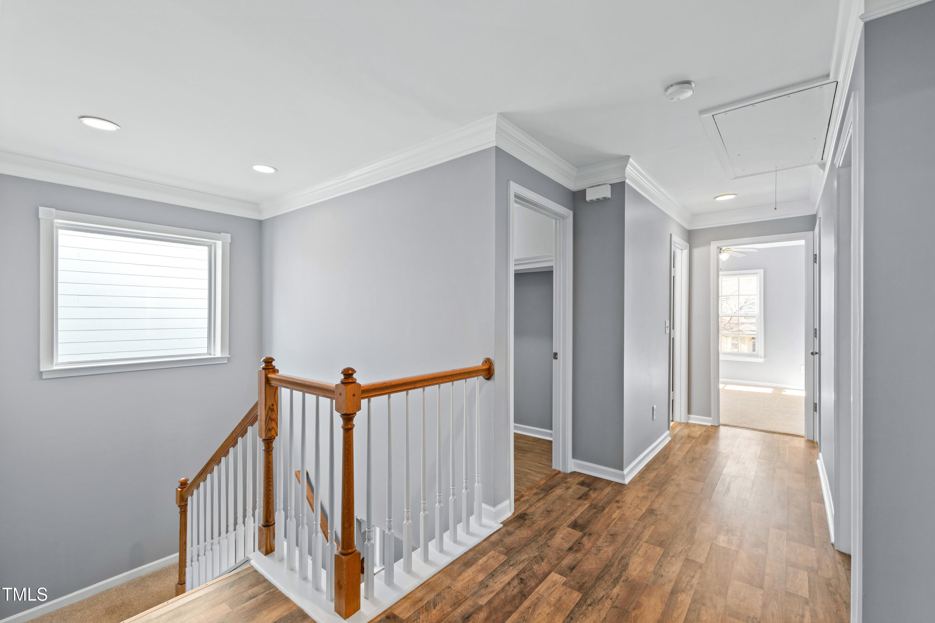 336 New Milford Road Cary, NC 27519 - Photo 19 of 53 a view of a hallway with wooden floor and staircase