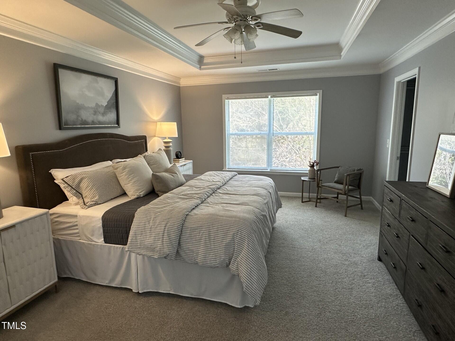 336 New Milford Road Cary, NC 27519 - Photo 21 of 53 a spacious bedroom with a bed and a chandelier