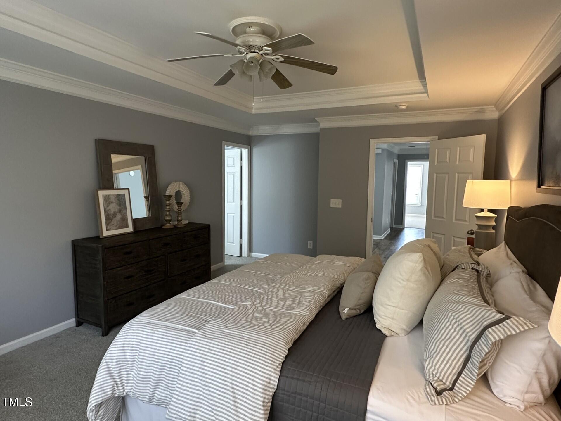 336 New Milford Road Cary, NC 27519 - Photo 22 of 53 a bedroom with a bed and a chandelier