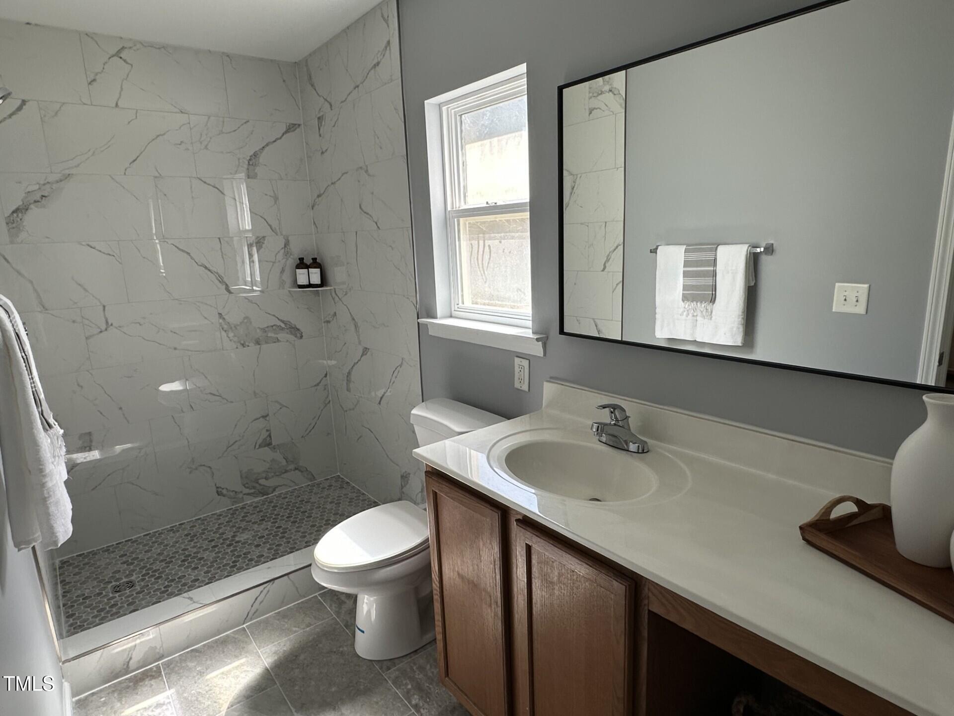 336 New Milford Road Cary, NC 27519 - Photo 23 of 53 a bathroom with a sink a toilet and shower
