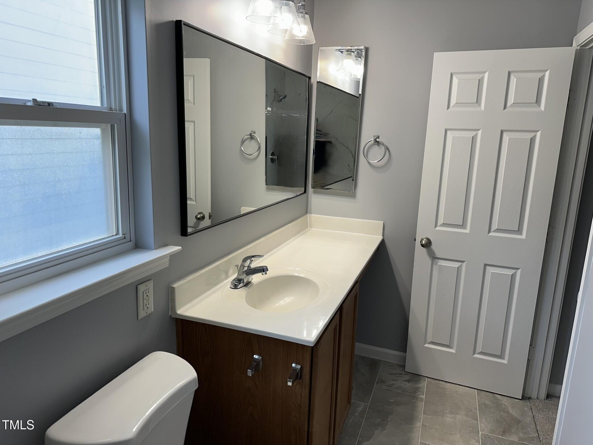 336 New Milford Road Cary, NC 27519 - Photo 28 of 53 a bathroom with a sink toilet and mirror