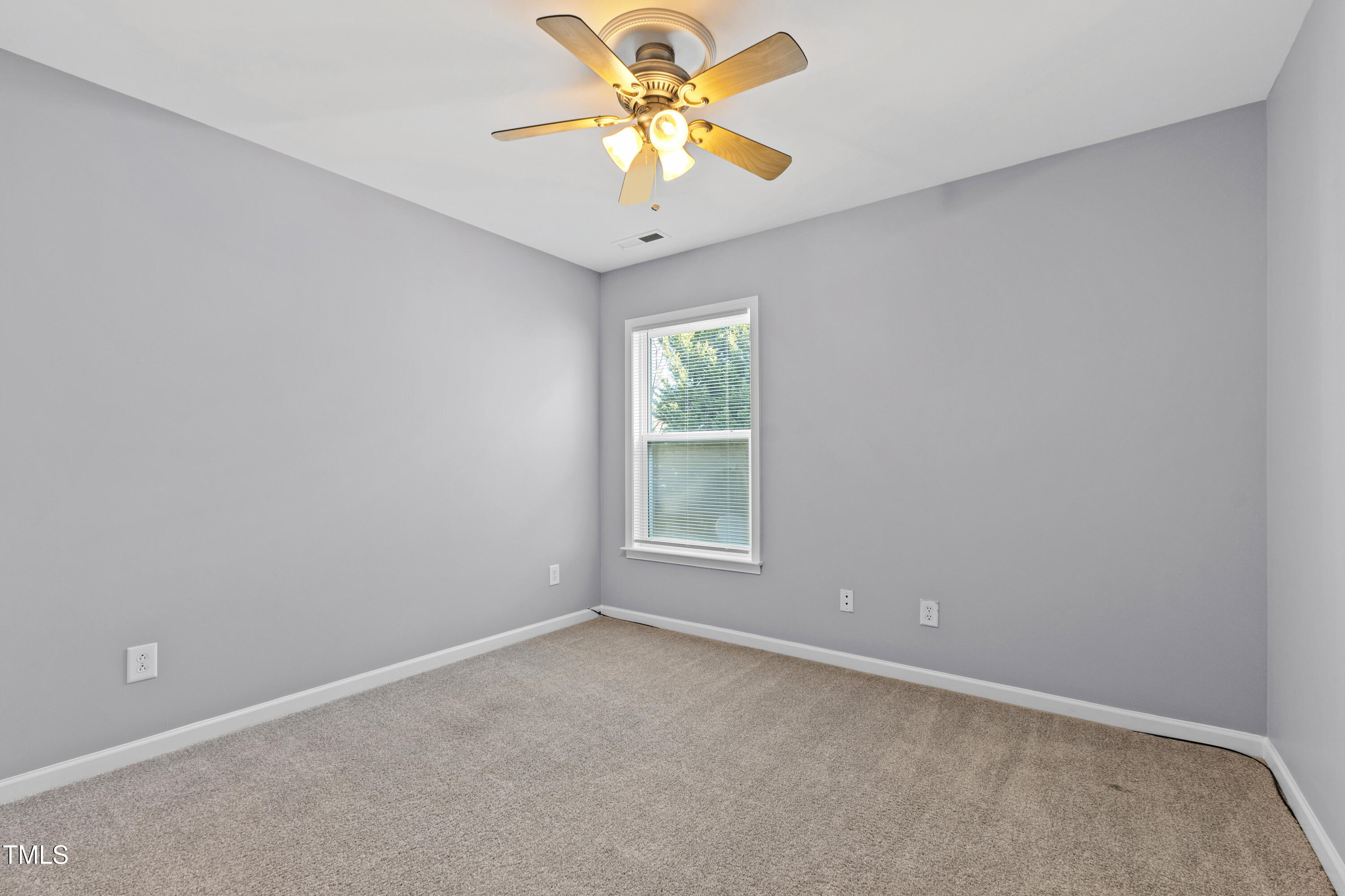 336 New Milford Road Cary, NC 27519 - Photo 32 of 53 an empty room with a window and a chandelier fan