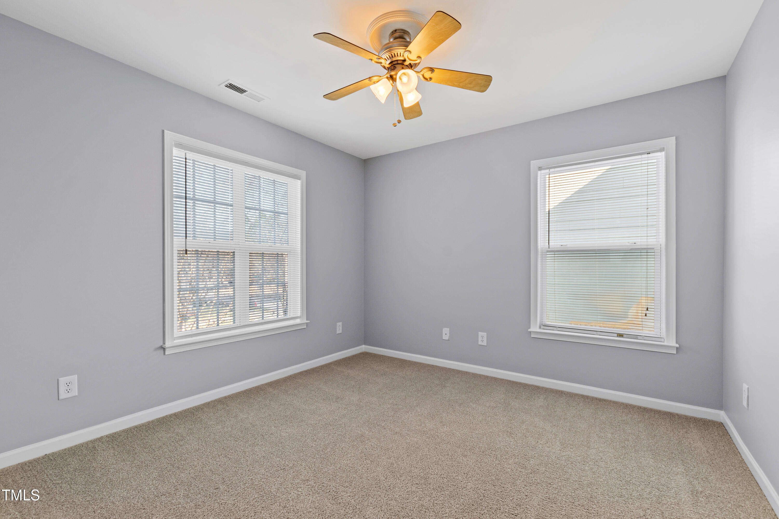 336 New Milford Road Cary, NC 27519 - Photo 34 of 53 an empty room with a window and a fan