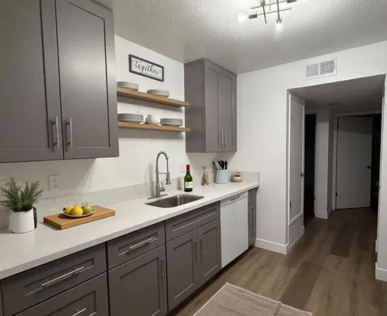 a kitchen with sink and cabinets