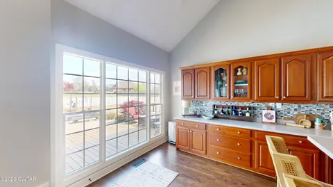 a kitchen with sink refrigerator and microwave