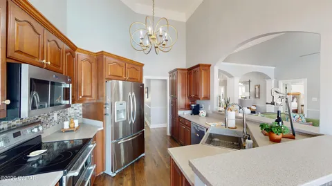 a living room with furniture and a large window with outer view