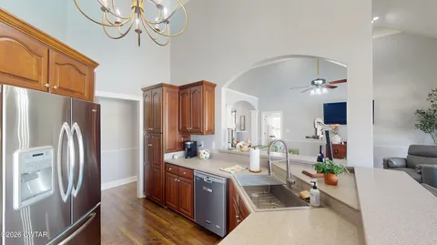 a large room with lots of counter space a large window and furniture