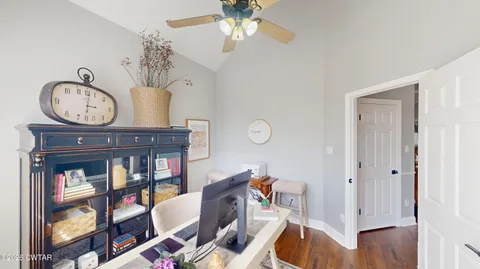 a bedroom with a bed a couches and large windows