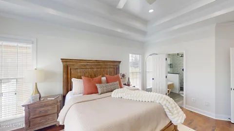 a bedroom with a large bed couch and a window