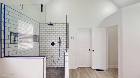 a bathroom with a sink a glass door shower and a mirror