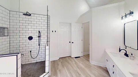 a bedroom with furniture and a large window