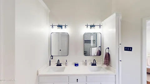 a bathroom with a sink vanity and a mirror