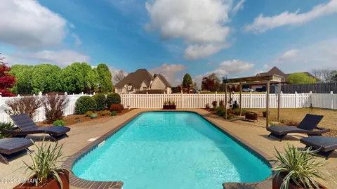 a view of swimming pool and lounge chair