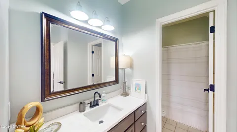 a bathroom with a shower curtain and a sink