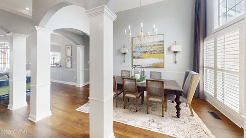 a view of a house with swimming pool and sitting area