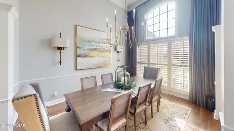 a living room with furniture fireplace and a large window
