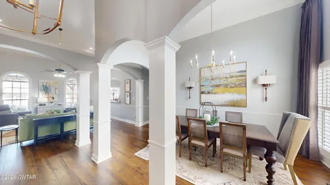 a view of a dining room with furniture and a window