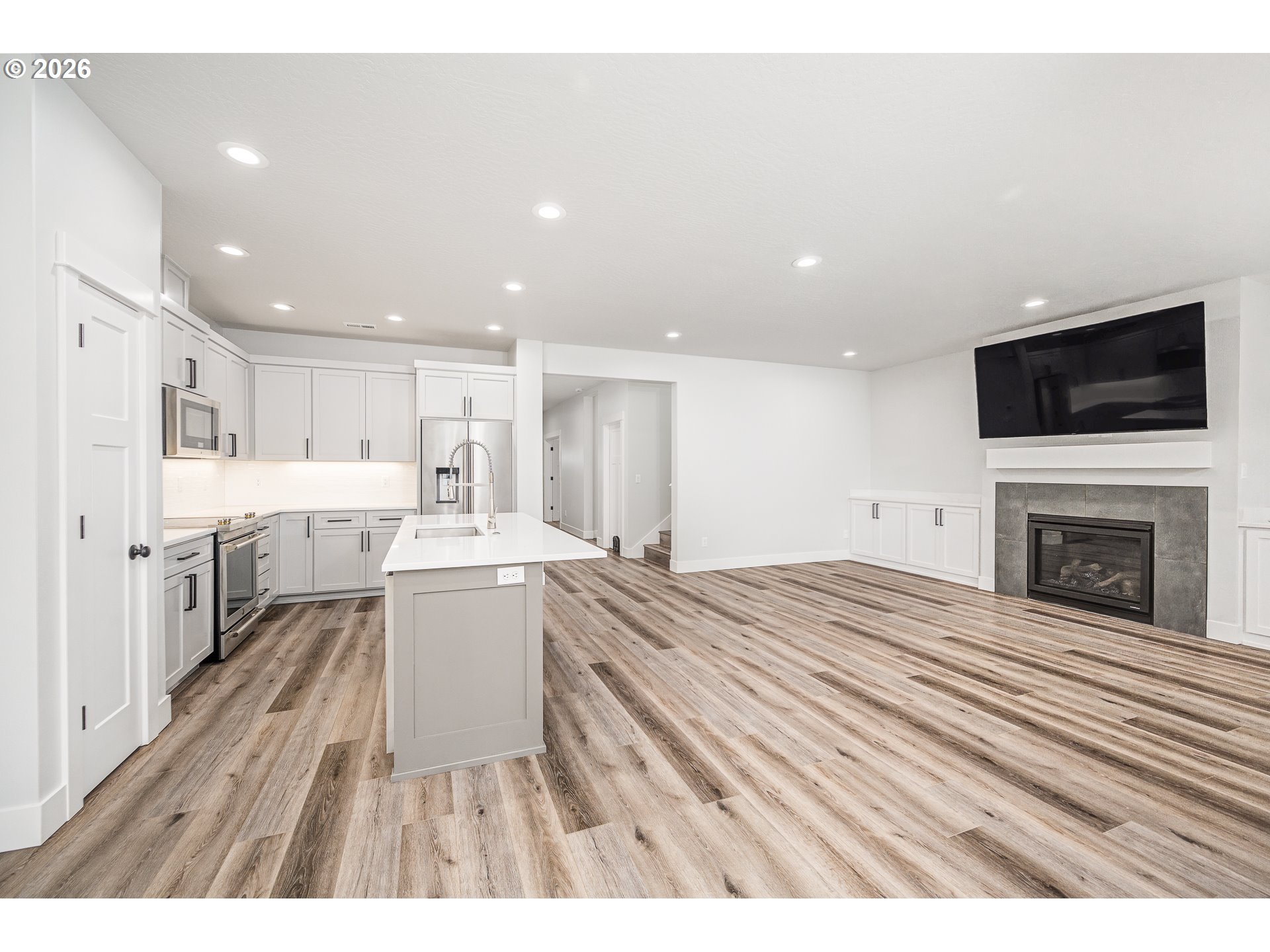 24678 Perkins Road, Unit LOT 26 Veneta, OR 97487 - Photo 13 of 48 a open kitchen with a sink and dishwasher stove top oven with wooden floor