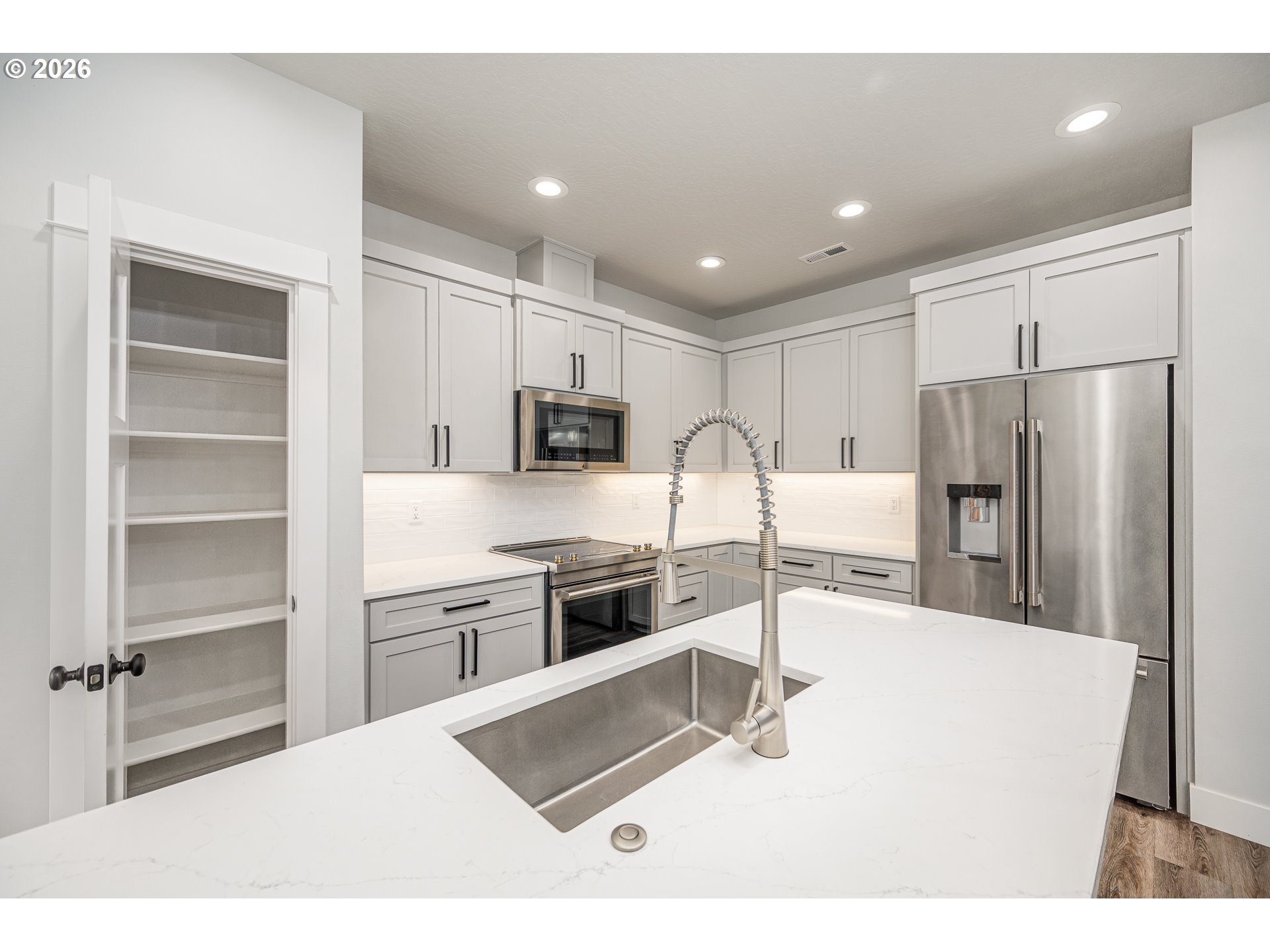 24678 Perkins Road, Unit LOT 26 Veneta, OR 97487 - Photo 15 of 48 a kitchen with stainless steel appliances kitchen island granite countertop a refrigerator and a stove top oven