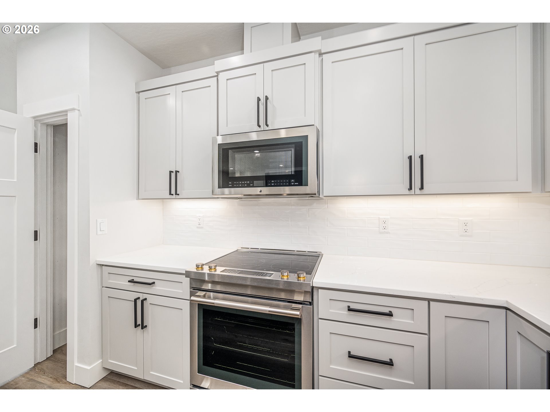 24678 Perkins Road, Unit LOT 26 Veneta, OR 97487 - Photo 18 of 48 a kitchen with stainless steel appliances white cabinets and a stove top oven