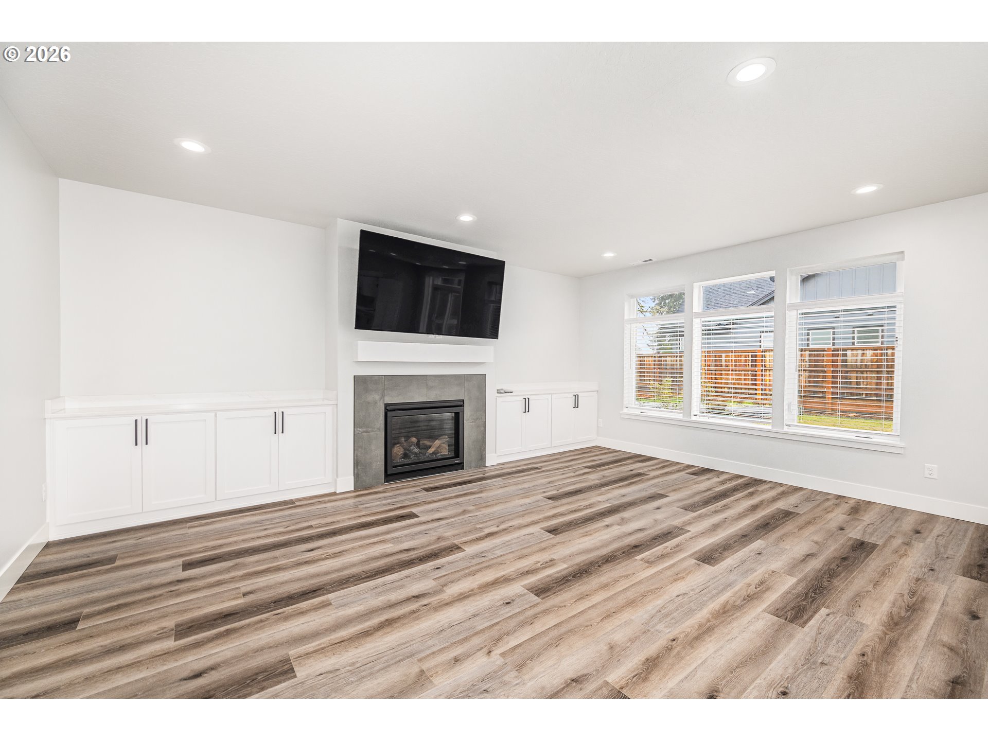 24678 Perkins Road, Unit LOT 26 Veneta, OR 97487 - Photo 9 of 48 a view of empty room with fireplace and wooden floor