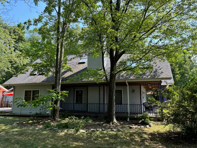 a bedroom with a bed and a dresser with mirror