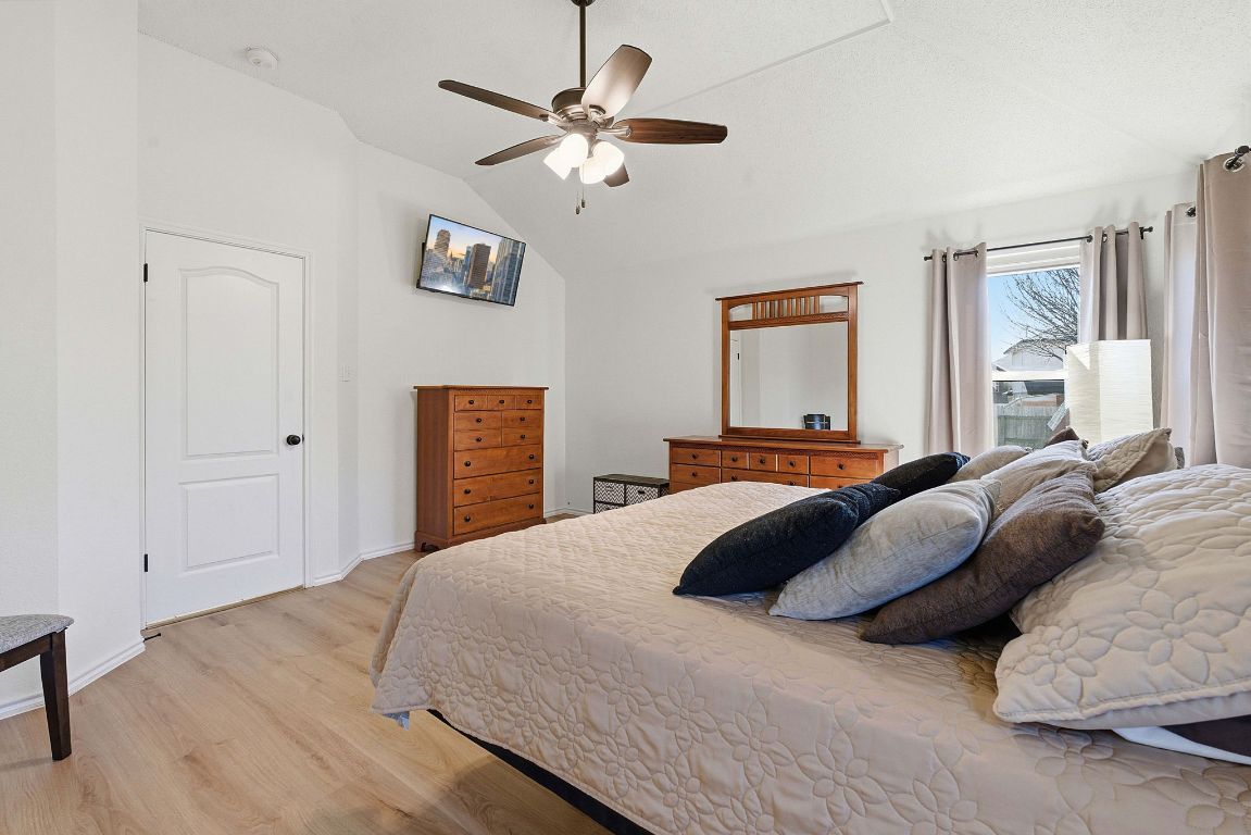 1203 Crossvine Way Pflugerville, TX 78660 - Photo 12 of 22 a bedroom with a bed ceiling fan and a window