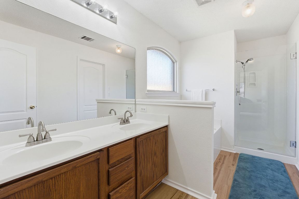 1203 Crossvine Way Pflugerville, TX 78660 - Photo 13 of 22 a bathroom with a sink and a mirror