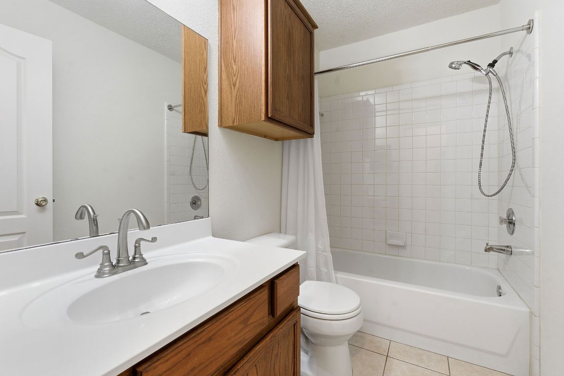 1203 Crossvine Way Pflugerville, TX 78660 - Photo 17 of 22 a bathroom with a sink a toilet and shower