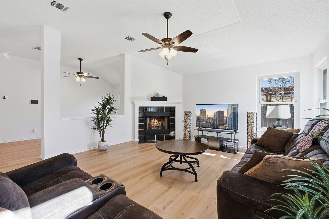 1203 Crossvine Way Pflugerville, TX 78660 - Photo 4 of 22 a living room with furniture and a chandelier