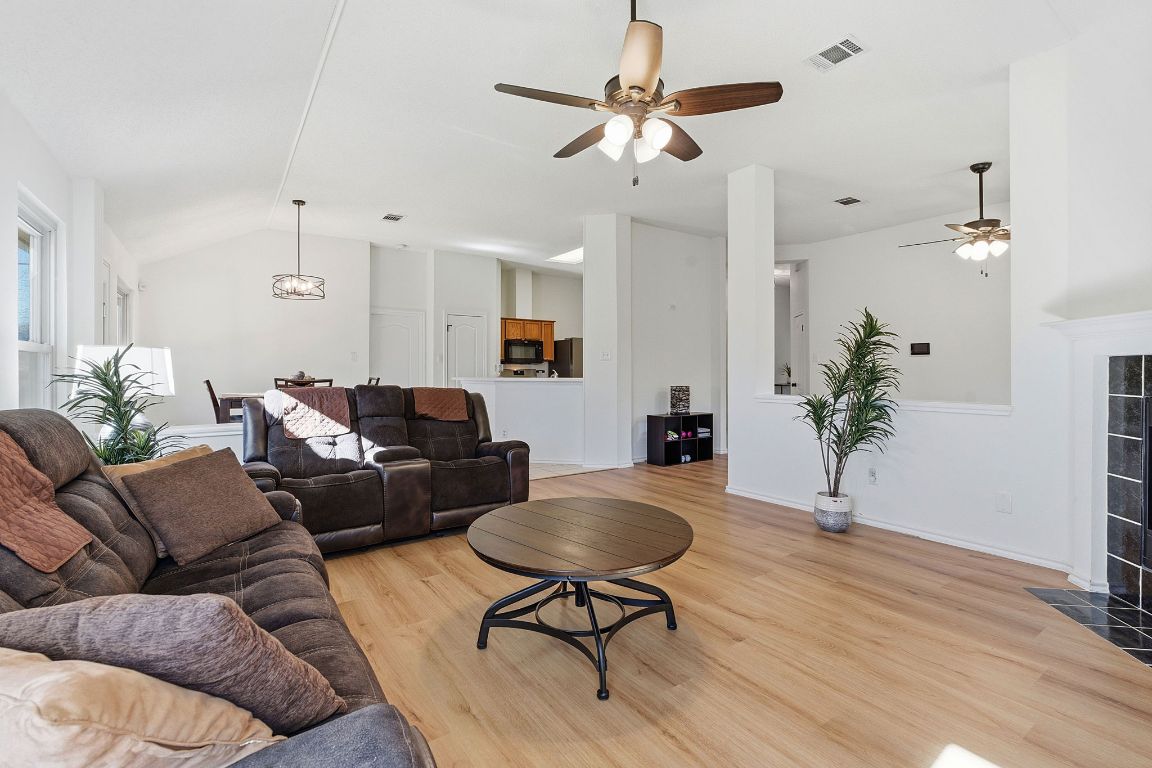 1203 Crossvine Way Pflugerville, TX 78660 - Photo 5 of 22 a living room with furniture a chandelier and a potted plant