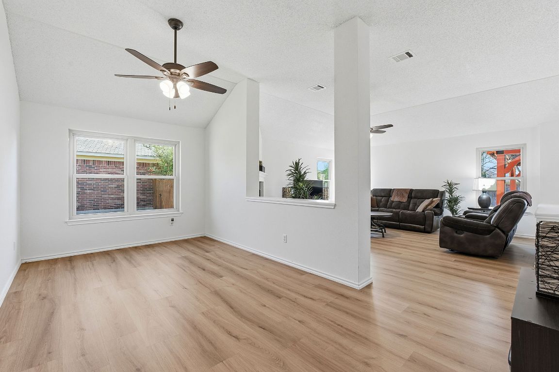 1203 Crossvine Way Pflugerville, TX 78660 - Photo 6 of 22 a living room with furniture and wooden floor