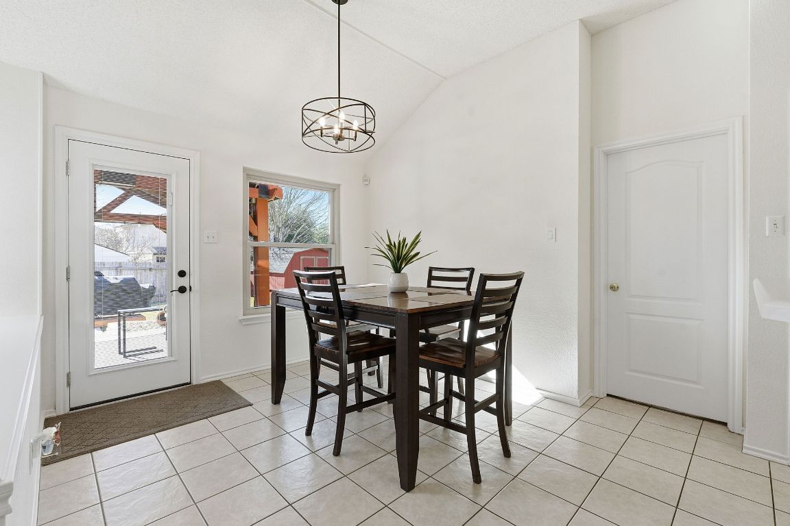 1203 Crossvine Way Pflugerville, TX 78660 - Photo 9 of 22 a view of a dining room with furniture and chandelier
