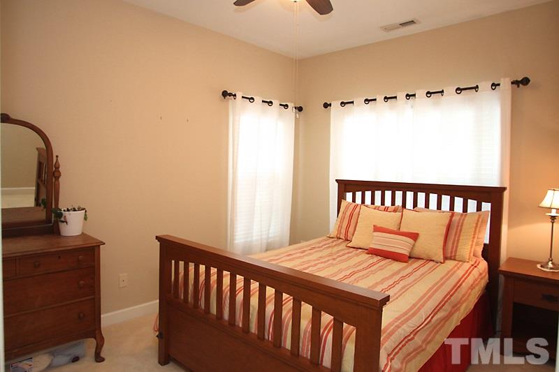 3520 Edgemont Drive Raleigh, NC 27612 - Photo 8 of 12 a bedroom with a bed and a dresser