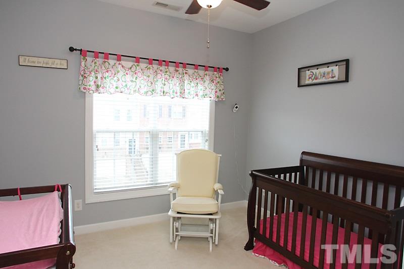 3520 Edgemont Drive Raleigh, NC 27612 - Photo 9 of 12 a bedroom with a bed and wooden floor