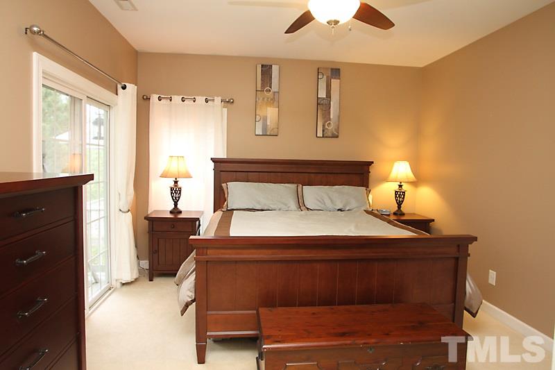 3520 Edgemont Drive Raleigh, NC 27612 - Photo 10 of 12 a bedroom with a bed and a potted plant