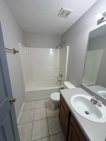 a bathroom with a double vanity sink toilet and shower
