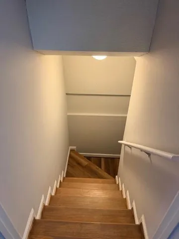 a view of a room with wooden floor