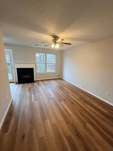 wooden floor fireplace and natural light in room