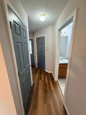 a view of a hallway and wooden floor