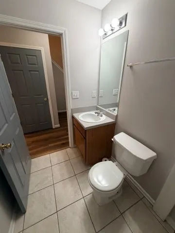 a bathroom with a sink a toilet a mirror and vanity