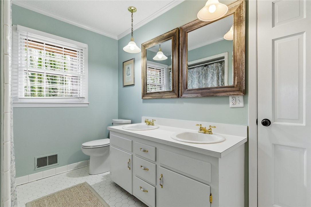 106 Cherokee Circle Anderson, SC 29621 - Photo 33 of 45 A well-appointed bathroom features a double vanity and dual framed mirrors, ready for morning routines.