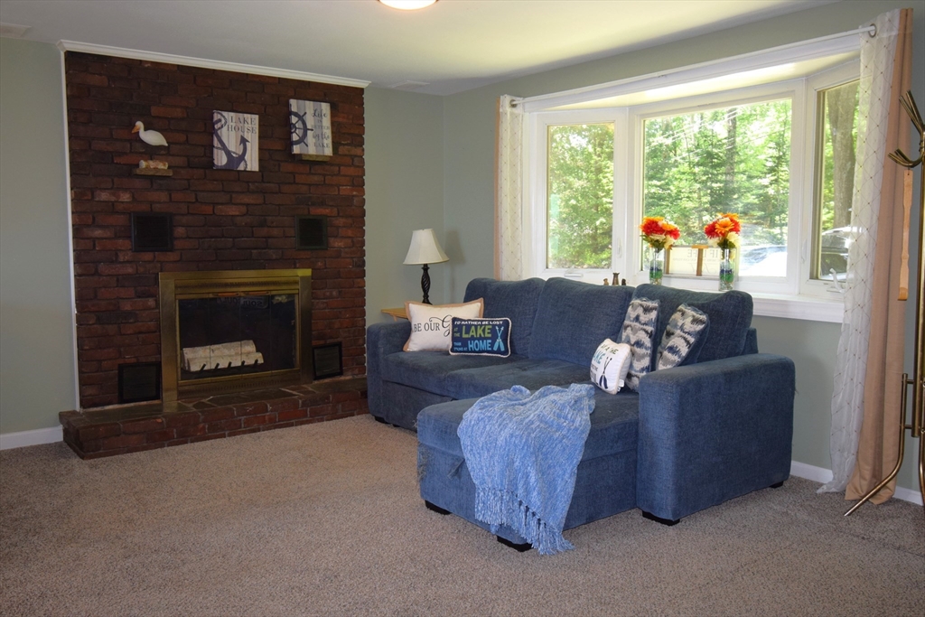 18 Holts Point Road Sandown, NH 03873 - Photo 11 of 34 a living room with furniture and a fireplace
