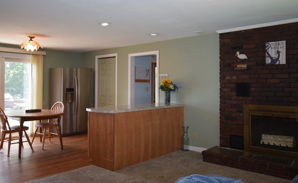 18 Holts Point Road Sandown, NH 03873 - Photo 12 of 34 a living room with furniture and a fireplace