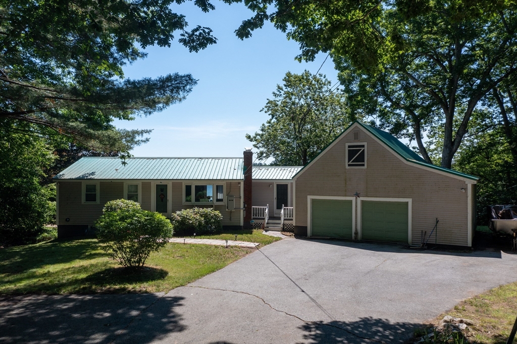 18 Holts Point Road Sandown, NH 03873 - Photo 2 of 34 a view of house with a yard and potted plants