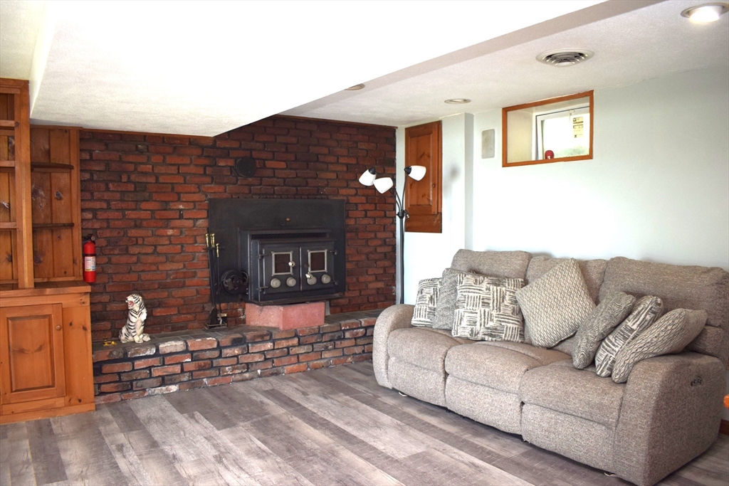 18 Holts Point Road Sandown, NH 03873 - Photo 23 of 34 a living room with furniture and a fireplace