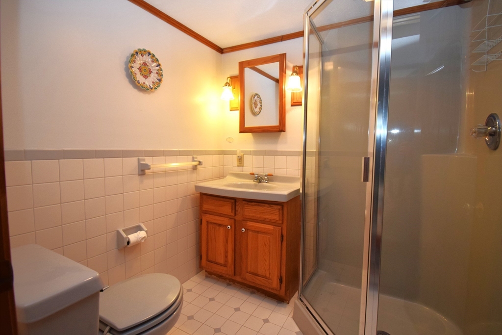 18 Holts Point Road Sandown, NH 03873 - Photo 28 of 34 a bathroom with a sink a toilet and shower