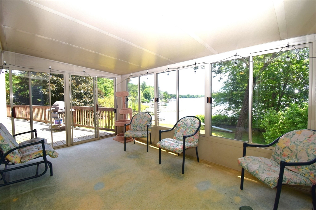 18 Holts Point Road Sandown, NH 03873 - Photo 9 of 34 a living room with furniture and floor to ceiling windows